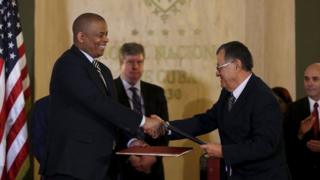Anthony Foxx and Adel Rodriguez shake hands