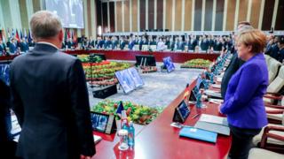 German Chancellor Angela Merkel (R) next to French Foreign Minister Jean-Marc Ayrault (L), along with other attendees, observe a moment of silence for the victims of the recent attack in Nice, France, at the beginning of the Asia-Europe Meeting (ASEM) Summit in Ulan Bator, Mongolia, 15 July 2016.
