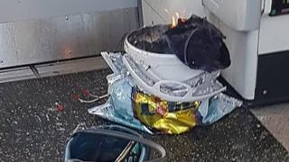 The device - a white bucket on fire inside a supermarket bag, with wires trailing on to the carriage floor