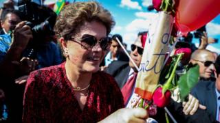 Dilma Rousseff receives flowers as she leaves Alvorada Palace in Brasilia. 6 Sept 2016