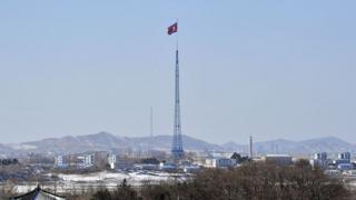 A North Korean flag flutters in the propaganda village of Gijeongdong