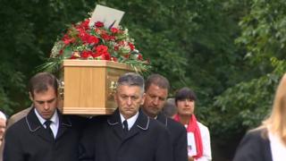 Spencer's coffin being carried at the church