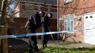 Police search the garden