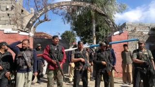 Policemen stand guard outside the courthouse in Charsadda, Pakistan, on 21 February 2017