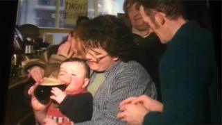 A baby drinking from a pint of Guinness as filmed by RTE