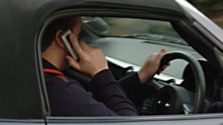 Driving while using a mobile phone