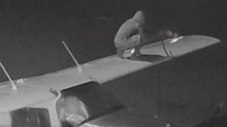 An unidentified boy siphons fuel from a light plane at Elcho Island Airport