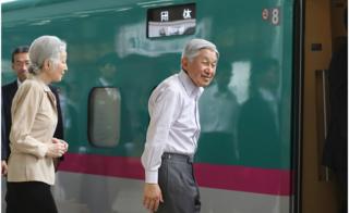 The Emperor and his wife board a bullet train in Tokyo