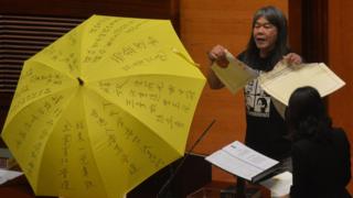 Leung Kwok-hung - known as "Long Hair" - of the League of Social Democrats shouts slogans and rips up the "831 ruling" before taking the Legislative Council Oath