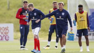 England physio Gary Lewin takes Harry Peak off the pitch