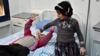 Syrian girls who had been held prisoner by rebel forces await treatment at a hospital in Aleppo following their release as part of a prisoner swap (12 April 2017)