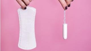 Women's hands holding sanitary products