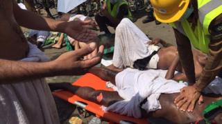 a pilgrim is treated by a medic after a stampede that killed and injured pilgrims in the holy city of Mina during the annual hajj pilgrimage