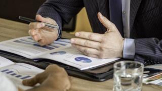 Hands on a document