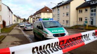 Police vehicles outside a migrant shelter that was targeted with a grenade