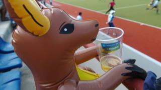 An inflatable kangaroo with a beer