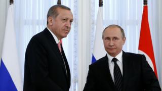 Russian President Putin shakes hands with Turkish President Erdogan during news conference following their meeting in St. Petersburg