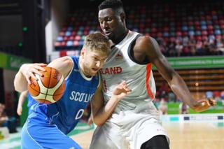 Michael Vigor of Scotland competes against Daniel Edozie of England in basketball