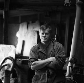A portrait of a man in overalls