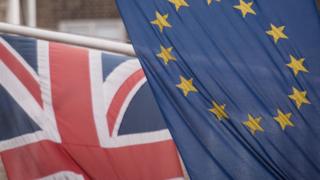 EU and UK flags fly above the EU Commission offices in Westminster