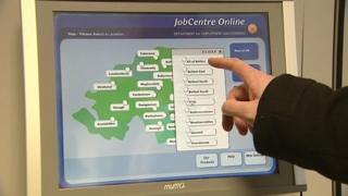 Jobseeker using touch screen machine in JobCentre