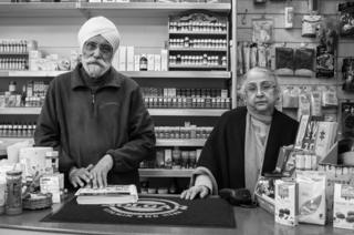 Mr and Mrs Singh Soor stand in their shop