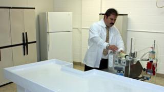 Dennis Kowalski preparing an operating table for the cryonics procedure