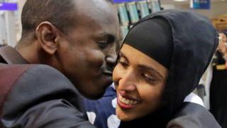 Somali refugee, caught in limbo after first travel ban, kisses his wife at Salt Lake International Airport