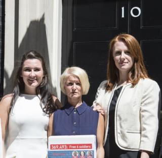 Yvonne MacHugh, Lisa Dunn and Joanne Thomlinson present a 350,000 signature petition