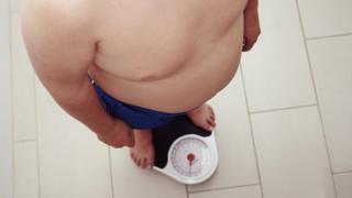 Obese person on scales