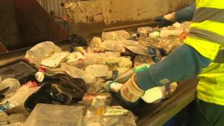 A worker sorts out recycling