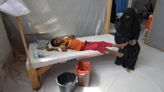 A woman sits next to her son who is infected with cholera at a hospital in the Red Sea port city of Hodeidah, Yemen, May 14, 2017.
