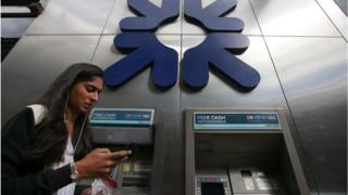 A woman walks past RBS