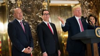 Cohn standing beside Trump