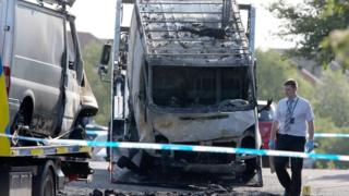 The two burnt out vans