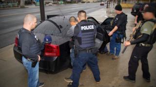 US Immigration officers detain a suspect in Los Angeles, California, 7/2/17