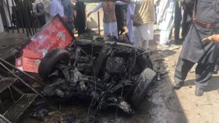 Pakistani security officials and residents gather at the site of a powerful explosion at a market in Parachinar, capital of the Kurram tribal district, on 31 March 2017