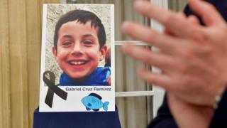 A photograph of young Gabriel Cruz is seen with a black ribbon as a sign of respect at the regional Government headquarters in Almeria