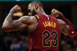 LeBron James of the Cleveland Cavaliers shows off his biceps after scoring a basket