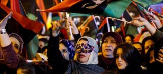 Libyans wave national flags as they attend a celebration marking the seventh anniversary of the Libyan revolution which toppled late leader and strongman Moamer Kadhafi, in the capital Tripoli's Martyrs Square on February 17, 2018.