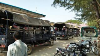 Police trucks in the town of Mrauk U