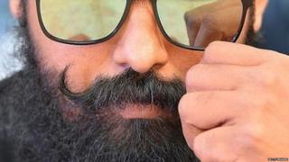 man holding mustache