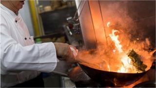 Chinese chef cooking vegetables