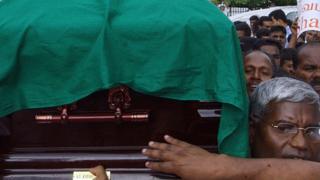 Sri Lankan political and anti-war activists carry the coffin of Tamil legislator Nadarajah Raviraj during a protest march held in Colombo against his assassination, 13 November 2006
