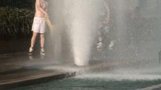 Young people playing with fire hydrant