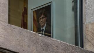 portrait of Carles Puigdemont seen through a window of the Palau de la Generalitat, 30 October 2017