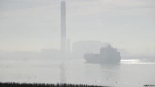 Container vessel makes its way along the River Thames