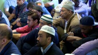 Muslim men worshipping at Friday prayers in Belfast