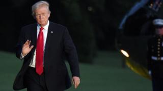 US President Donald Trump waves as he returns to the White House in Washington, DC.