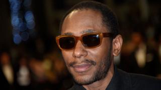 This file photo taken on May 17, 2015 shows US rapper Yasiin Bey formerly Mos Def posing as he arrives for the screening of the film "Amy" at the 68th Cannes Film Festival in Cannes, southeastern France